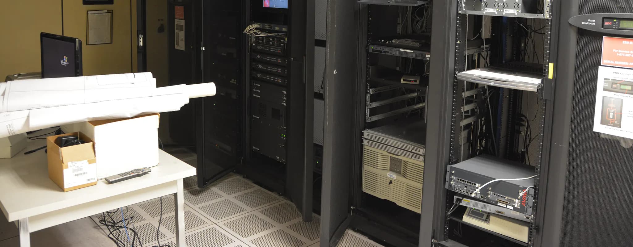 Open server racks and network equipment in a data room.