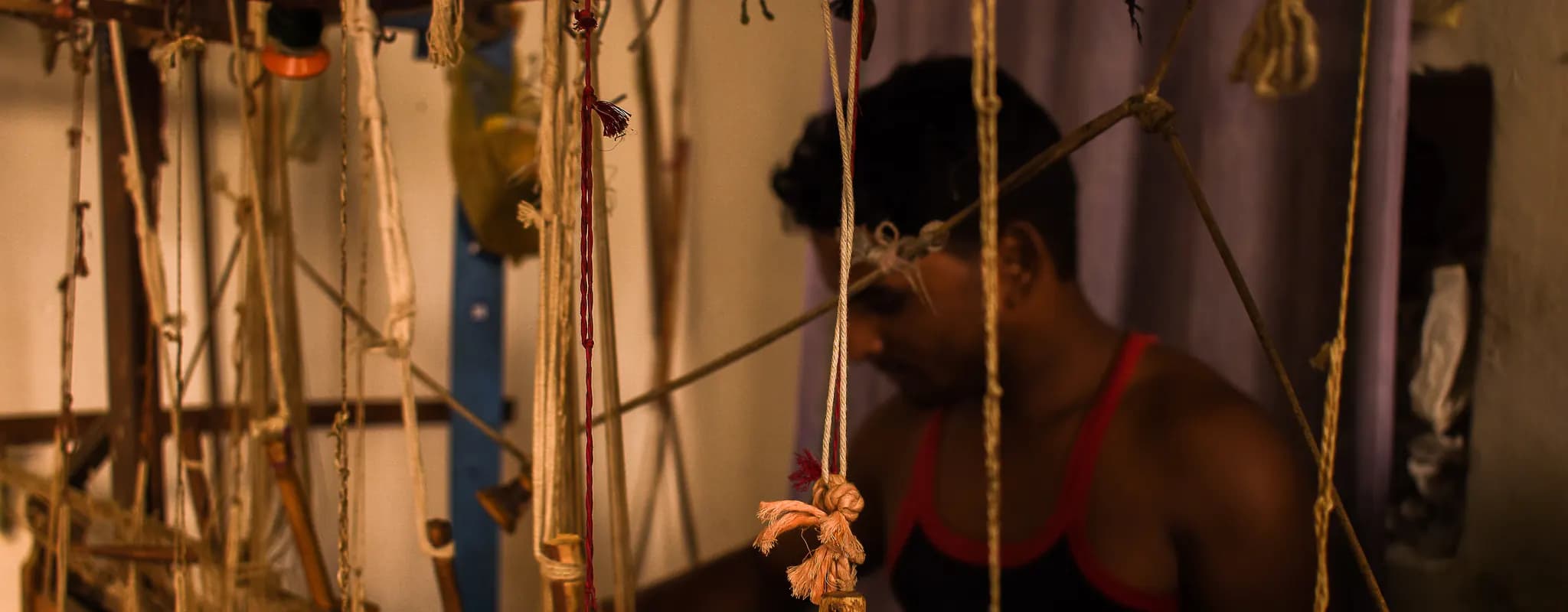 A silk weaver works at a handloom in Chanderi, Madhya Pradesh.