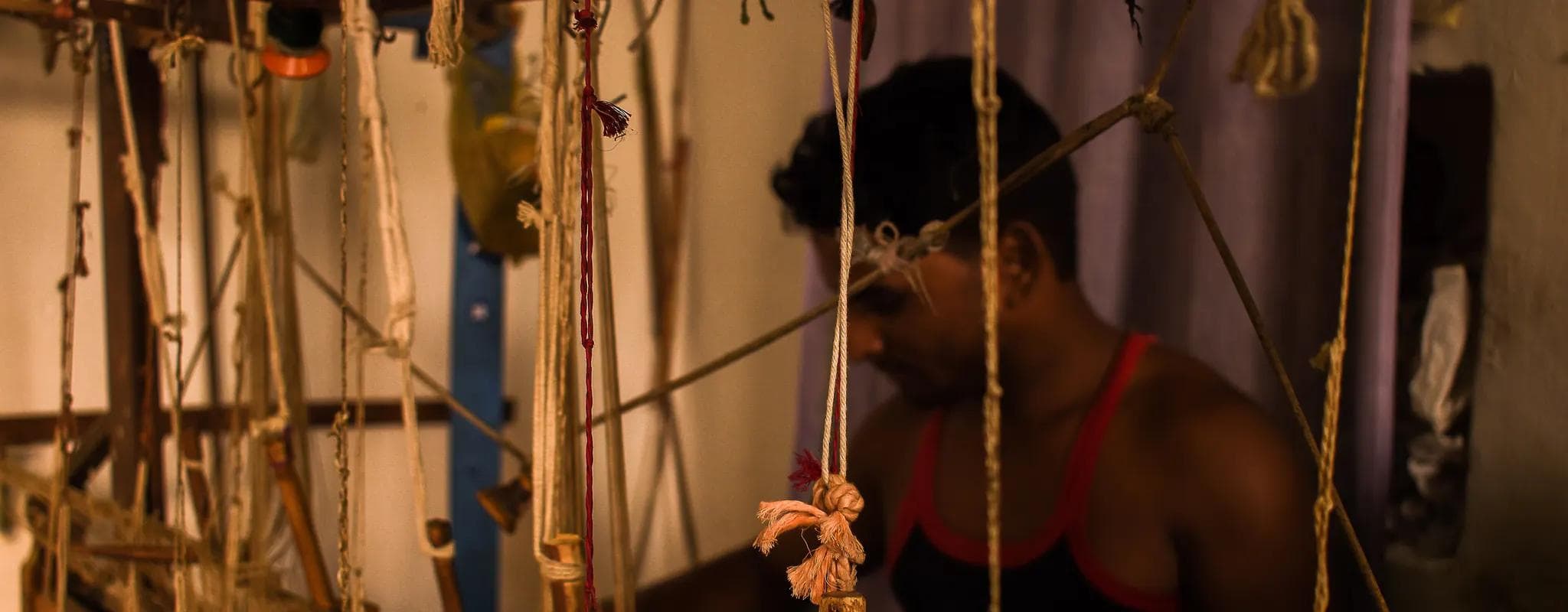 A silk weaver works at a handloom in Chanderi, Madhya Pradesh.